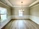 Formal dining room with tray ceiling, chandelier, and elegant wainscoting at 152 Southern Estates Dr, Sanford, NC 27330
