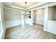 Elegant dining room featuring wainscoting, crown molding, and modern lighting fixtures at 152 Southern Estates Dr, Sanford, NC 27330