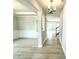 Bright hallway with beautiful hardwood flooring, opening up to multiple rooms and a staircase at 152 Southern Estates Dr, Sanford, NC 27330