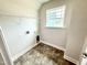 Compact laundry room with vinyl flooring, window, and utility connections at 152 Southern Estates Dr, Sanford, NC 27330
