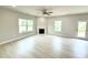 Bright living room with a fireplace, large windows, and a door to the exterior at 152 Southern Estates Dr, Sanford, NC 27330