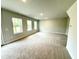 Spacious living room featuring plush carpeting, recessed lighting, and bright windows for natural light at 152 Southern Estates Dr, Sanford, NC 27330