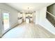 Open concept living room featuring an island kitchen and a staircase with iron spindles at 152 Southern Estates Dr, Sanford, NC 27330