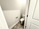 Compact powder room featuring a toilet and tile flooring for a functional space at 152 Southern Estates Dr, Sanford, NC 27330