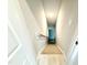 Well-lit stairwell with neutral-toned walls and carpeted steps leads to the next level of the home at 152 Southern Estates Dr, Sanford, NC 27330