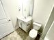 Bathroom featuring a single sink vanity with chrome fixtures and a standard toilet at 303 Bishop Ln, Sanford, NC 27330