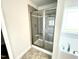 Modern bathroom features a glass enclosed shower and separate soaking tub next to a window at 303 Bishop Ln, Sanford, NC 27330