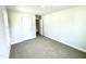 Bedroom with neutral walls, carpet and a door leading to the hallway at 303 Bishop Ln, Sanford, NC 27330