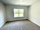 Bright bedroom featuring plush carpeting and a large window with a view of lush greenery at 303 Bishop Ln, Sanford, NC 27330