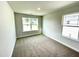 Inviting bedroom space with light walls and carpet, featuring a window with neighborhood views at 303 Bishop Ln, Sanford, NC 27330