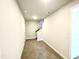 Hallway with neutral walls and carpeted flooring that leads to the staircase at 303 Bishop Ln, Sanford, NC 27330