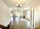 Spacious living room featuring hardwood floors, a ceiling fan, and a cozy fireplace at 303 Bishop Ln, Sanford, NC 27330