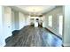 Hardwood floors and white walls connect the living room to kitchen at 303 Bishop Ln, Sanford, NC 27330