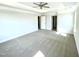 Bright and airy main bedroom featuring a tray ceiling, a ceiling fan, and plush carpeting at 303 Bishop Ln, Sanford, NC 27330