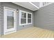 New back deck features gray siding, a white door, and double-paned windows at 125 Sugar Run Dr # 26, Fuquay Varina, NC 27526