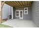 A covered back patio features a door, windows, and a new A/C unit at 125 Sugar Run Dr # 26, Fuquay Varina, NC 27526