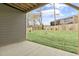 Expansive backyard with lush green grass, a wood fence, and a modern building view at 125 Sugar Run Dr # 26, Fuquay Varina, NC 27526