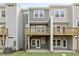 Exterior view of a multilevel deck and patio with manicured lawn at 125 Sugar Run Dr # 26, Fuquay Varina, NC 27526