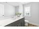 Bathroom featuring gray vanity with white countertop and a decorative mirror and plant at 125 Sugar Run Dr # 26, Fuquay Varina, NC 27526