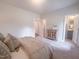 Neutral bedroom featuring a dresser, doorway to a bathroom and a closet at 125 Sugar Run Dr # 26, Fuquay Varina, NC 27526