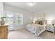 A cozy bedroom is furnished with a queen-sized bed, dresser, and glass door to the backyard at 125 Sugar Run Dr # 26, Fuquay Varina, NC 27526