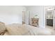 Neutral bedroom showcasing wood accent cabinet and adjoining bathroom and closet at 125 Sugar Run Dr # 26, Fuquay Varina, NC 27526