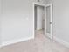 Bright bedroom showcasing a glass paneled door, and a view into the neutral hallway at 125 Sugar Run Dr # 26, Fuquay Varina, NC 27526
