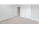 Neutral bedroom with a closet, open doorway and plush neutral carpet at 125 Sugar Run Dr # 26, Fuquay Varina, NC 27526