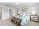 Bright, neutral bedroom features an upholstered headboard, and a wooden bench at 125 Sugar Run Dr # 26, Fuquay Varina, NC 27526