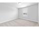 Cozy bedroom featuring neutral carpet, clean white walls, and a window with natural light at 125 Sugar Run Dr # 26, Fuquay Varina, NC 27526