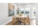 Bright dining area features a round table, four chairs, and natural light from a window at 125 Sugar Run Dr # 26, Fuquay Varina, NC 27526