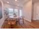 Bright dining room featuring hardwood floors, a modern table with seating and natural light at 125 Sugar Run Dr # 26, Fuquay Varina, NC 27526