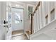 Inviting entryway with an open door, white trim, and wood-finished stairs with light neutral walls at 125 Sugar Run Dr # 26, Fuquay Varina, NC 27526