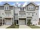 Charming townhomes featuring a two-car garage, balcony, and craftsman-style architectural elements at 125 Sugar Run Dr # 26, Fuquay Varina, NC 27526