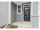 A black front door with silver hardware is surrounded by gray siding and trim at 125 Sugar Run Dr # 26, Fuquay Varina, NC 27526