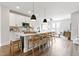 Bright, open kitchen with white cabinetry, pendant lighting, a breakfast bar, and hardwood floors at 125 Sugar Run Dr # 26, Fuquay Varina, NC 27526
