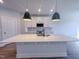 Modern kitchen island with white quartz countertop at 125 Sugar Run Dr # 26, Fuquay Varina, NC 27526