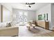 Cozy living room with a view to the outside through white-framed glass doors at 125 Sugar Run Dr # 26, Fuquay Varina, NC 27526