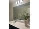 Bathroom featuring a white vanity with a large mirror and modern lighting at 323 Chestnut Oak Ln, Lillington, NC 27546