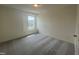 Comfortable bedroom featuring plush carpeting and bright natural light from the window at 323 Chestnut Oak Ln, Lillington, NC 27546