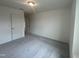 Bedroom featuring plush carpeting, closet, and natural light from open doorway at 323 Chestnut Oak Ln, Lillington, NC 27546