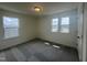 Cozy bedroom featuring plush carpeting and bright natural light from multiple windows at 323 Chestnut Oak Ln, Lillington, NC 27546