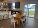 Dining area adjacent to kitchen featuring a table, seating for six, and a view of the backyard at 323 Chestnut Oak Ln, Lillington, NC 27546