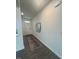 Inviting hallway with modern wood flooring, a decorative rug, and a sleek mirror at 323 Chestnut Oak Ln, Lillington, NC 27546