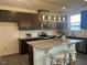 Modern kitchen featuring a large island with seating, granite countertops, and stainless steel appliances at 323 Chestnut Oak Ln, Lillington, NC 27546