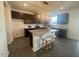 Modern kitchen featuring a large island with seating, granite countertops, and stainless steel appliances at 323 Chestnut Oak Ln, Lillington, NC 27546