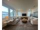 Bright living room with large windows, comfortable seating, and stylish decor at 323 Chestnut Oak Ln, Lillington, NC 27546