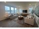 Bright living room with large windows, comfortable seating, and stylish decor at 323 Chestnut Oak Ln, Lillington, NC 27546