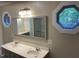 Bright bathroom featuring a double sink vanity, a large mirror, and natural light at 3309 Westcott Cir, Sanford, NC 27330