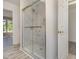 Modern bathroom showcasing a glass enclosed shower and an open doorway to a bedroom at 3309 Westcott Cir, Sanford, NC 27330